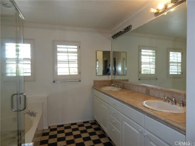 a bathroom with a granite countertop sink a toilet and mirror