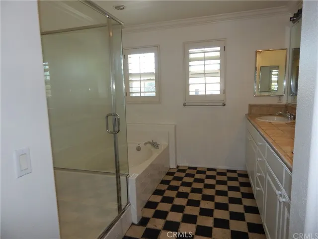a bathroom with a black and white checkered floor