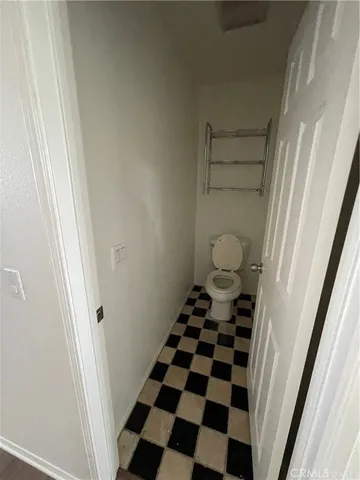a bathroom with a black and white checkered floor