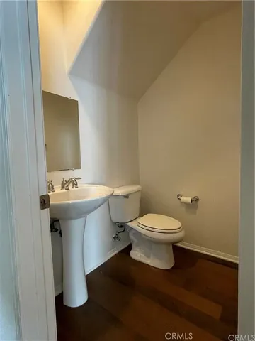 a bathroom with a sink toilet and mirror