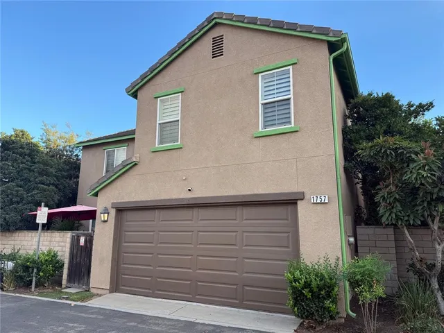 a front view of a house with plants