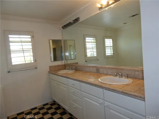a bathroom with a granite countertop sink a mirror and a window