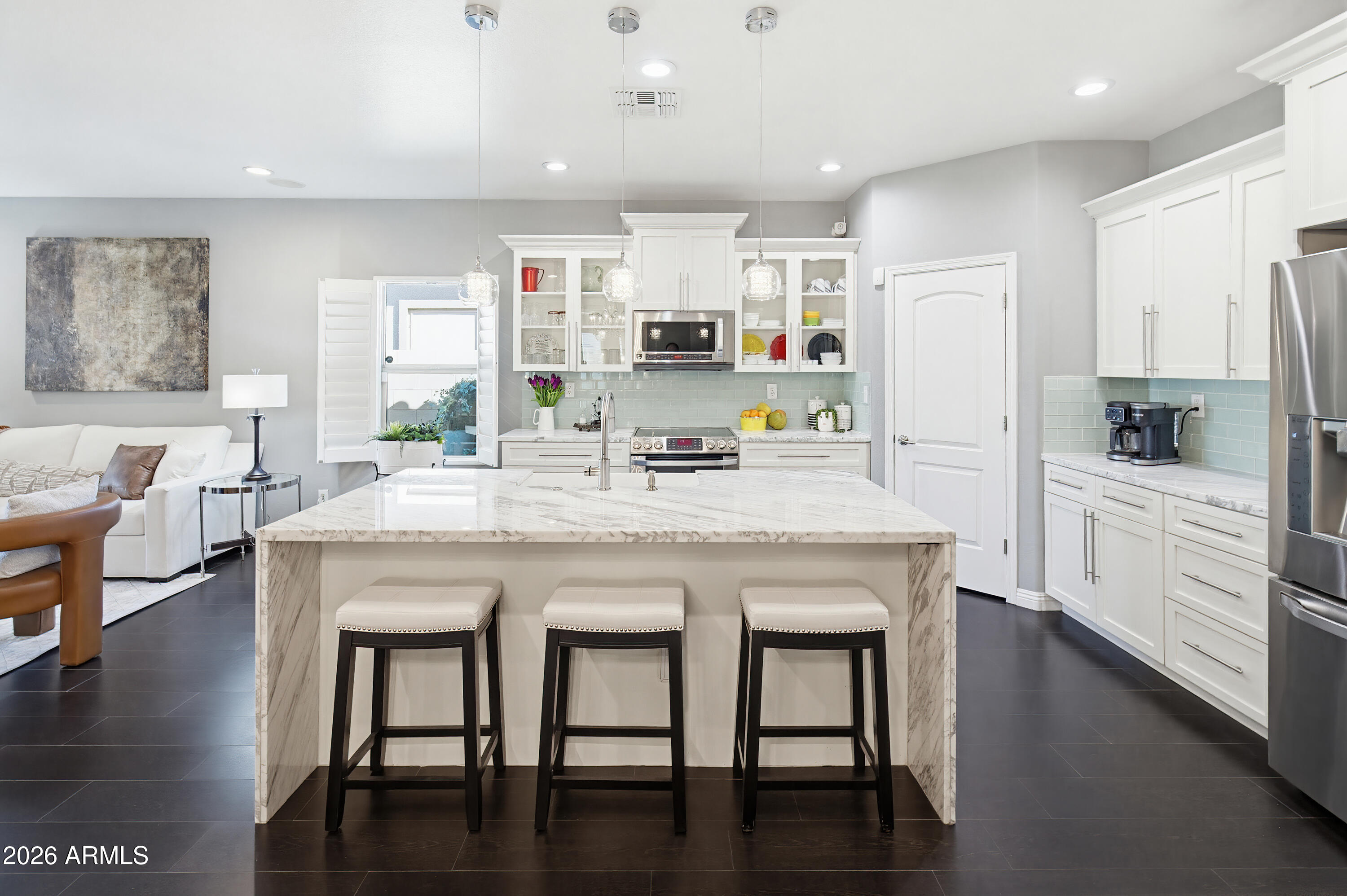 a kitchen with granite countertop a table chairs stove and cabinets