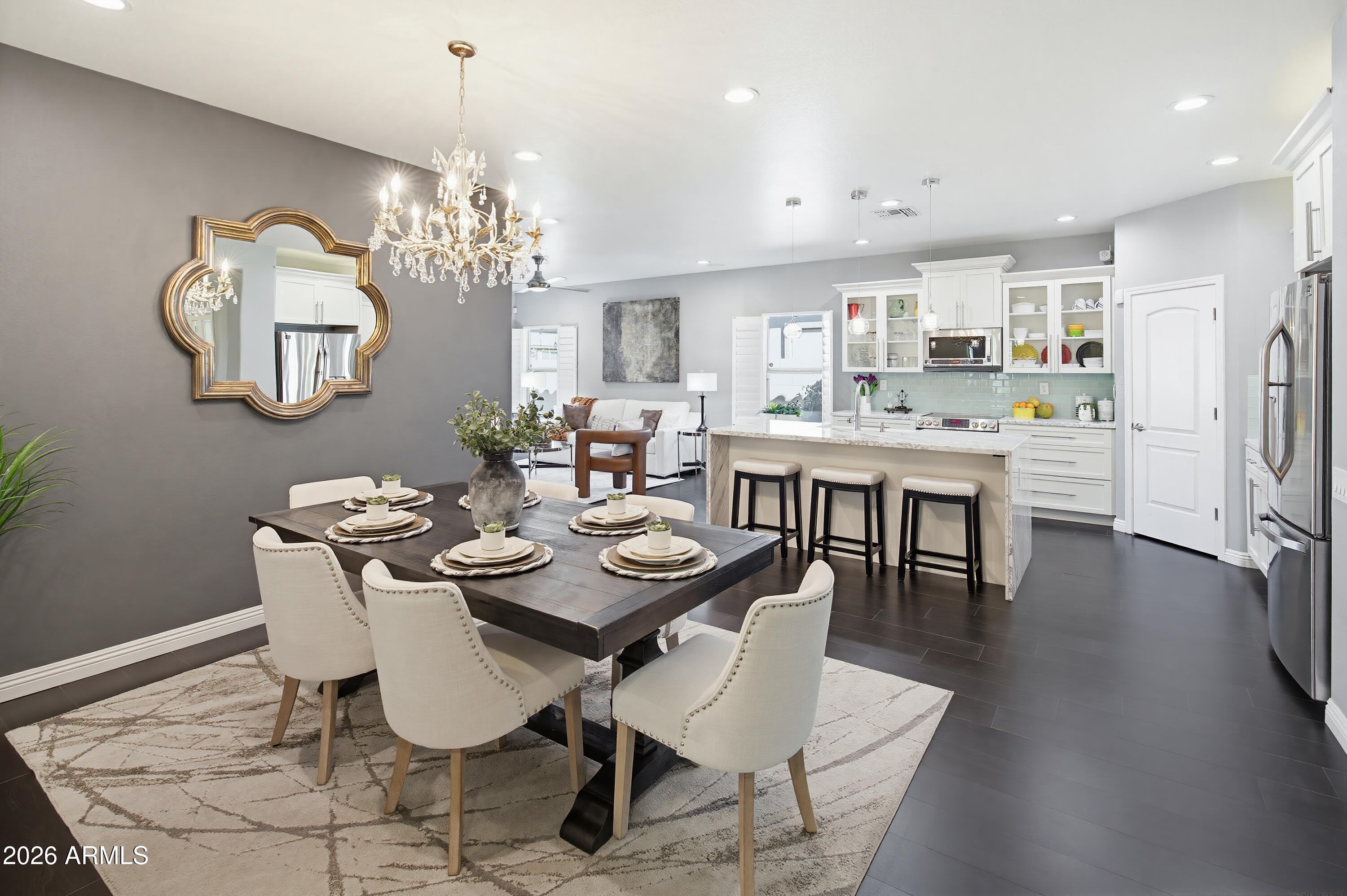 10772 West Yearling Road Peoria, AZ 85383 - Photo 12 of 39 a dining room with wooden floor a chandelier a wooden table and chairs