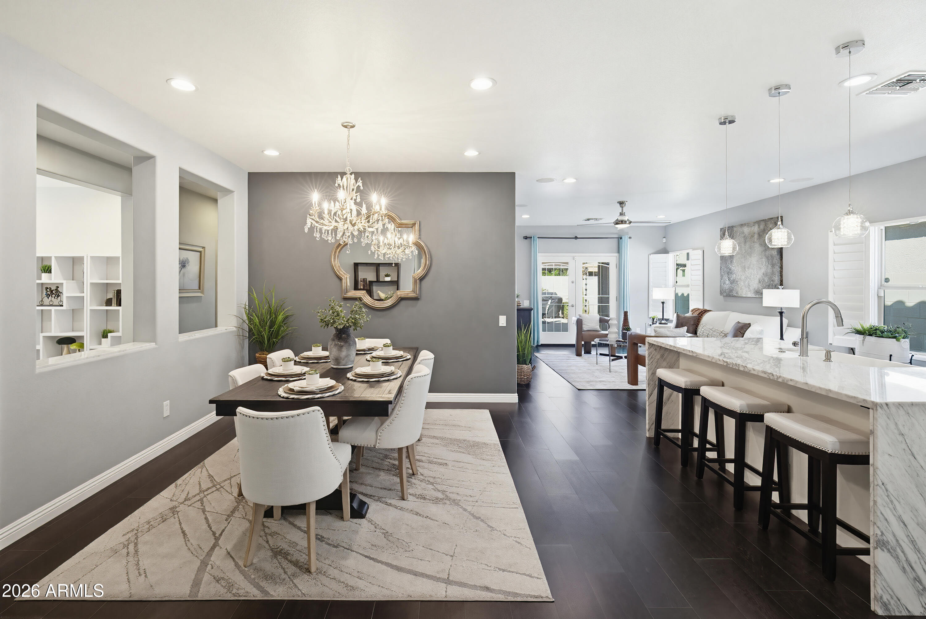10772 West Yearling Road Peoria, AZ 85383 - Photo 14 of 39 a dining room with wooden floor a chandelier a wooden table and chairs