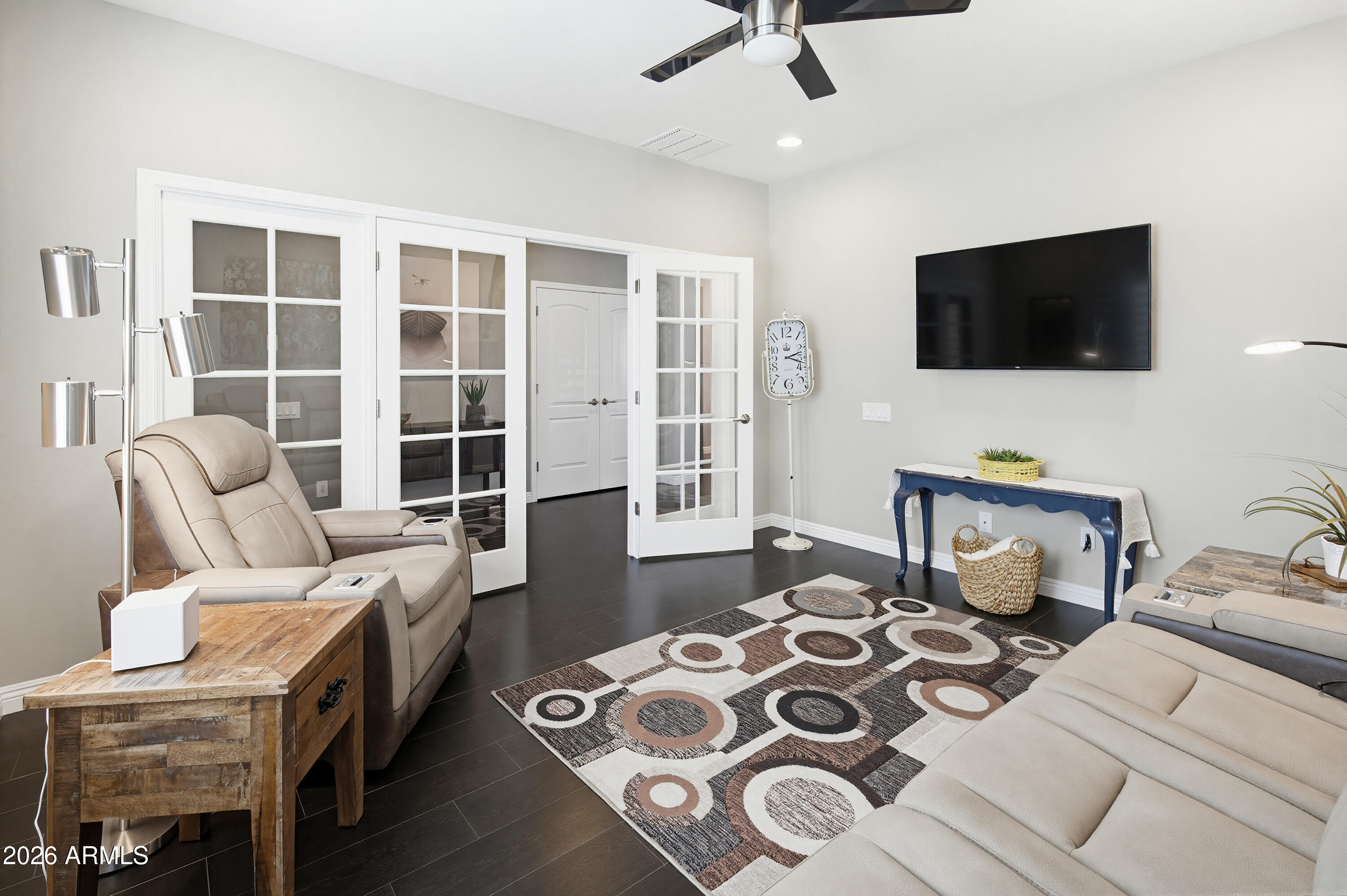 10772 West Yearling Road Peoria, AZ 85383 - Photo 18 of 39 a living room with furniture and a flat screen tv