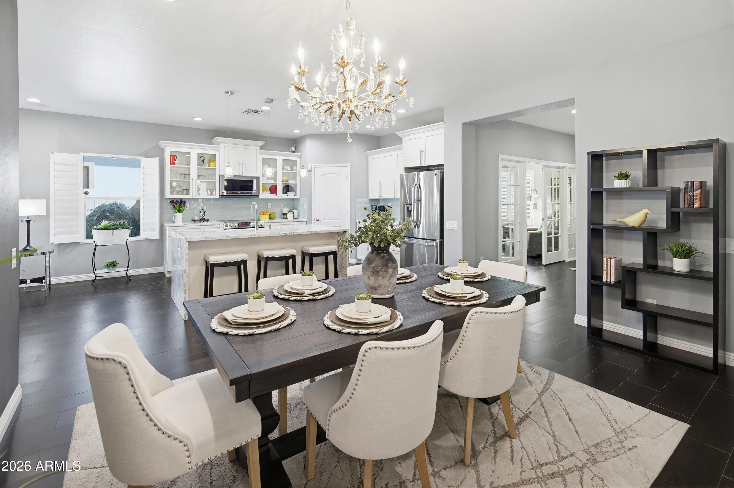 10772 West Yearling Road Peoria, AZ 85383 - Photo 2 of 39 a view of a dining room with furniture wooden floor and chandelier