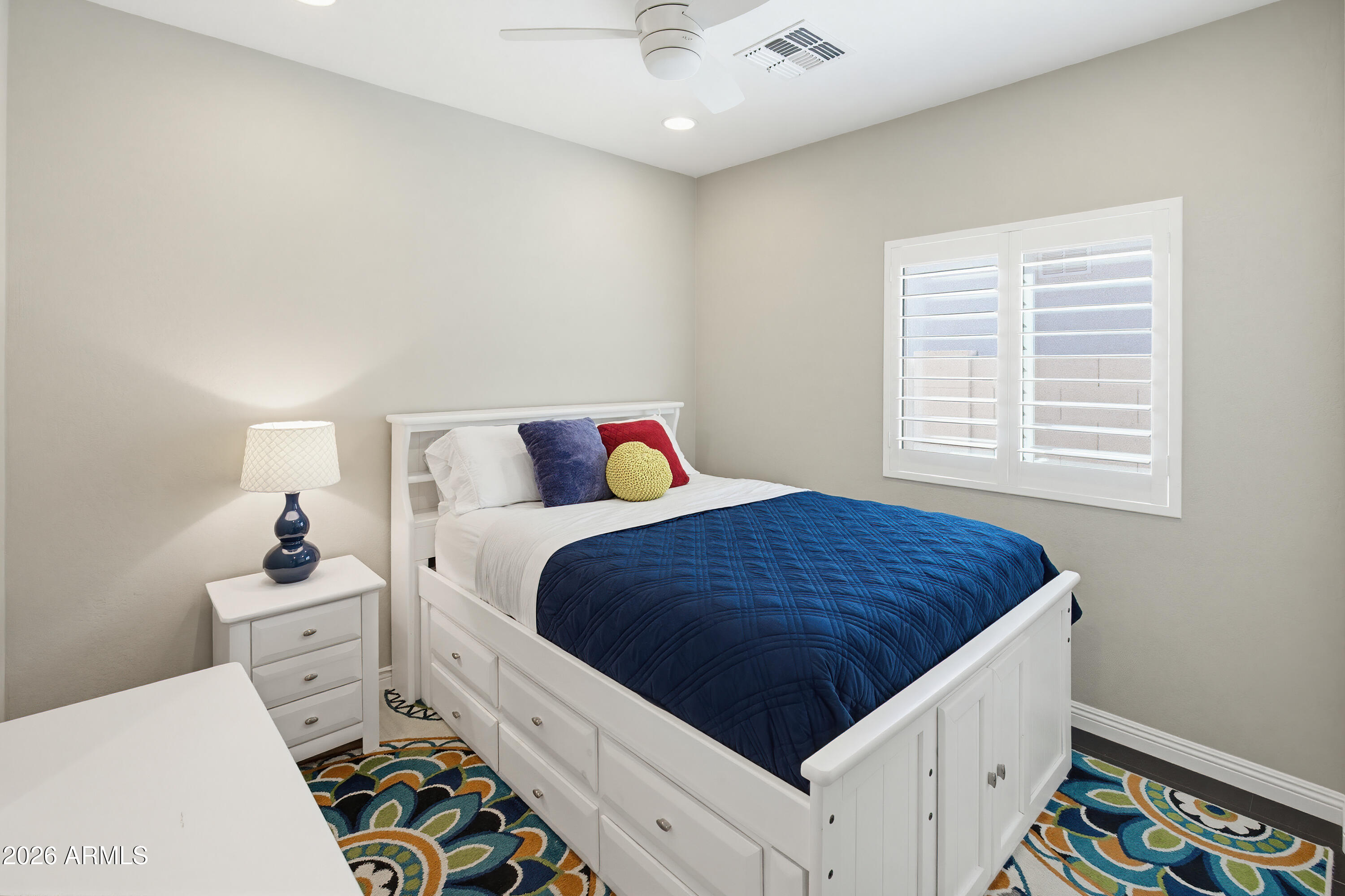 10772 West Yearling Road Peoria, AZ 85383 - Photo 21 of 39 a bedroom with a bed and window