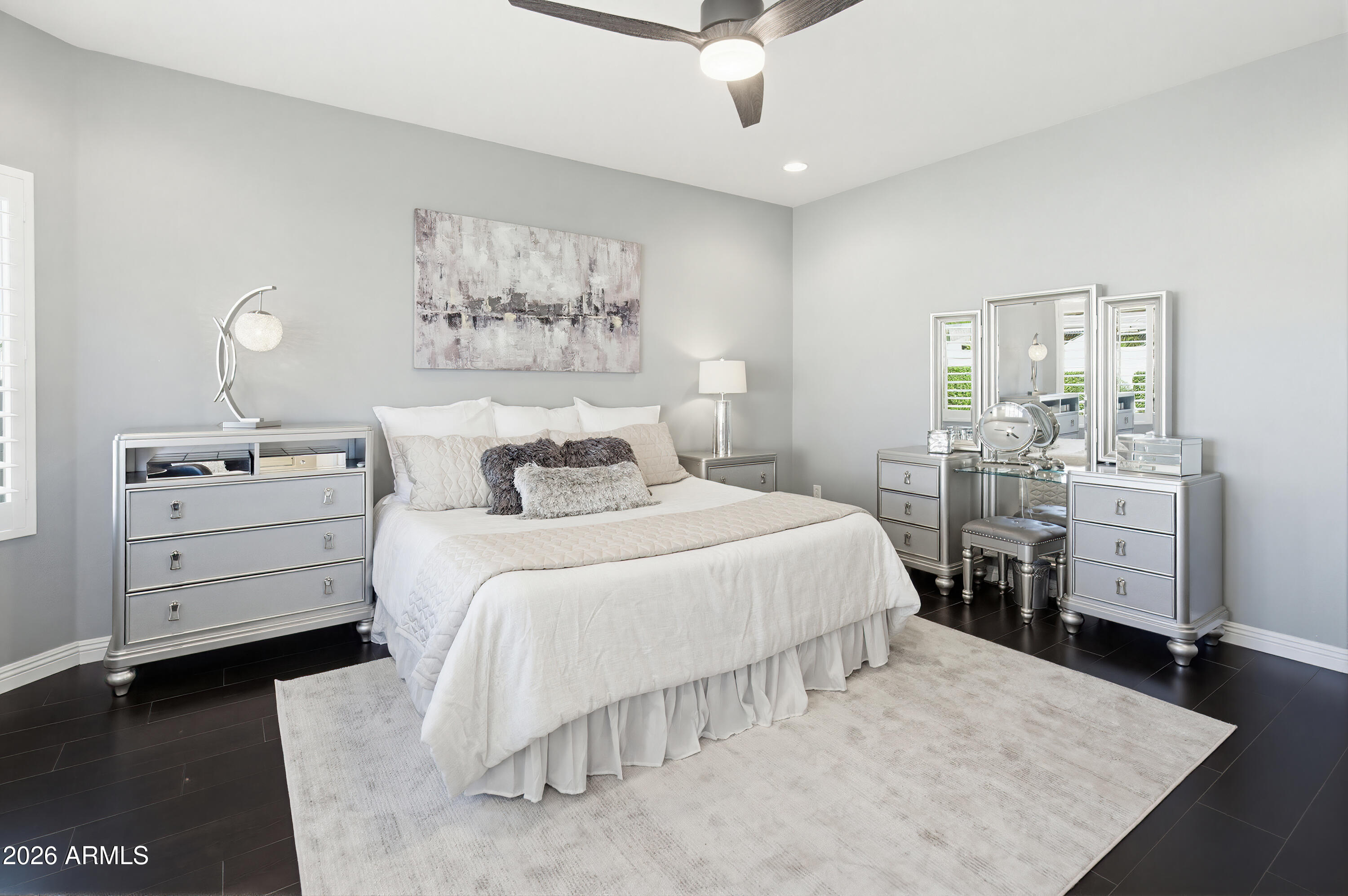 10772 West Yearling Road Peoria, AZ 85383 - Photo 25 of 39 a bedroom with a bed and wooden floor