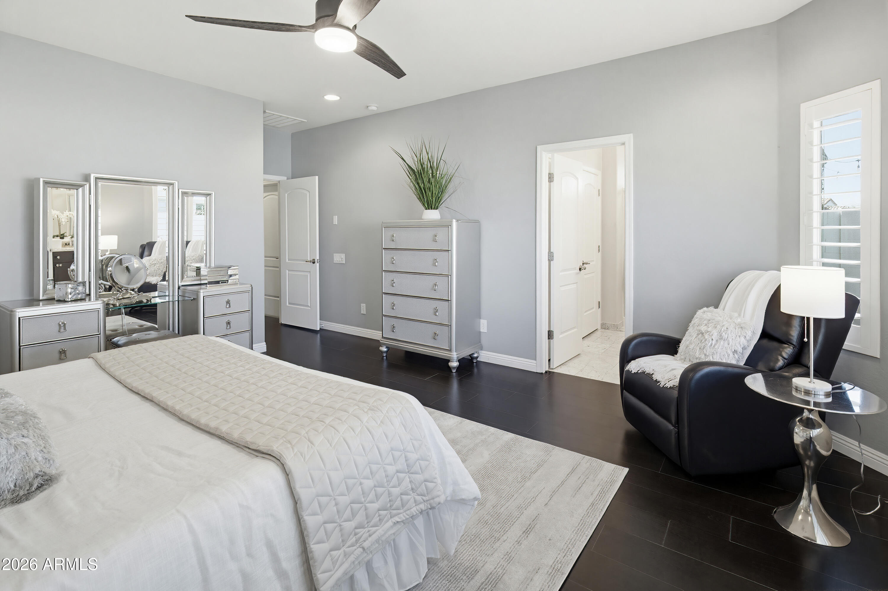 10772 West Yearling Road Peoria, AZ 85383 - Photo 26 of 39 a spacious bedroom with a bed and furniture