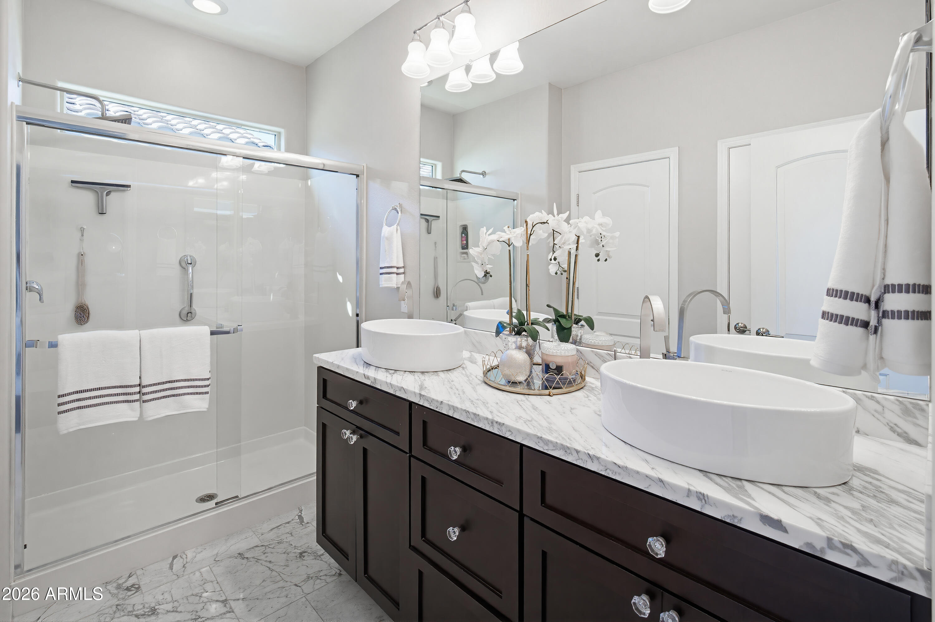 10772 West Yearling Road Peoria, AZ 85383 - Photo 28 of 39 a bathroom with a granite countertop sink a mirror and a shower
