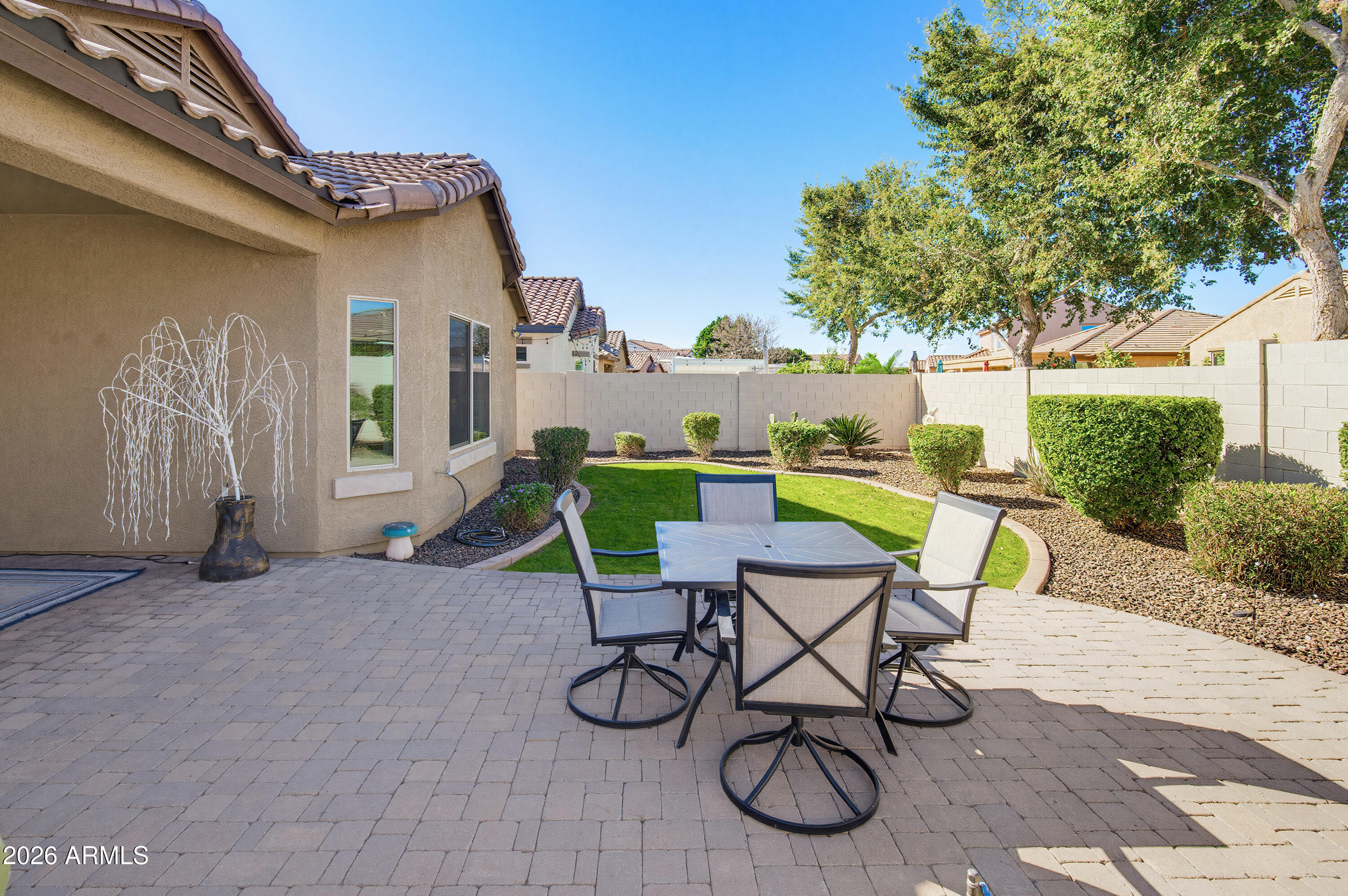 10772 West Yearling Road Peoria, AZ 85383 - Photo 31 of 39 a view of patio with table and chairs and potted plants