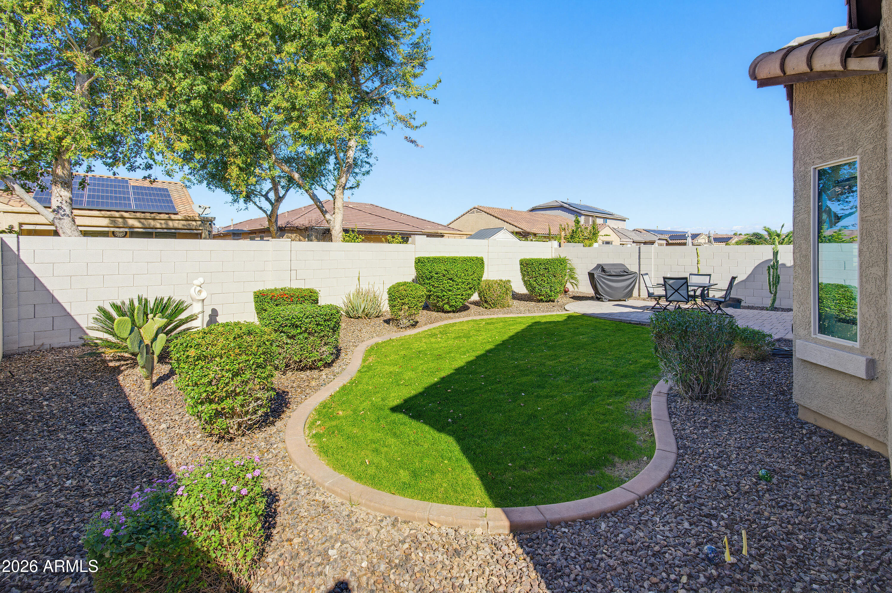 10772 West Yearling Road Peoria, AZ 85383 - Photo 33 of 39 a view of a house with a yard and sitting area