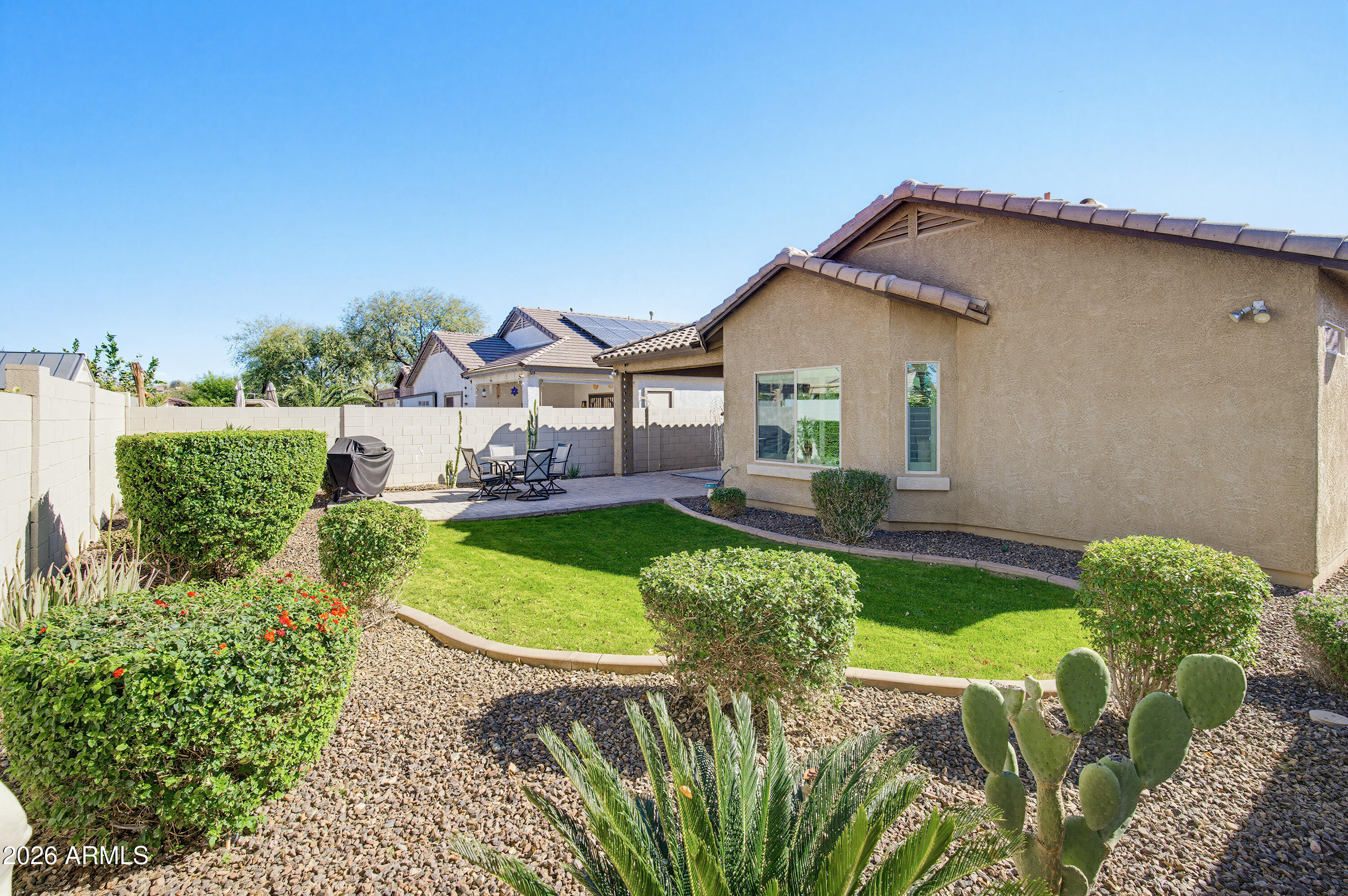 10772 West Yearling Road Peoria, AZ 85383 - Photo 34 of 39 a front view of a house with garden