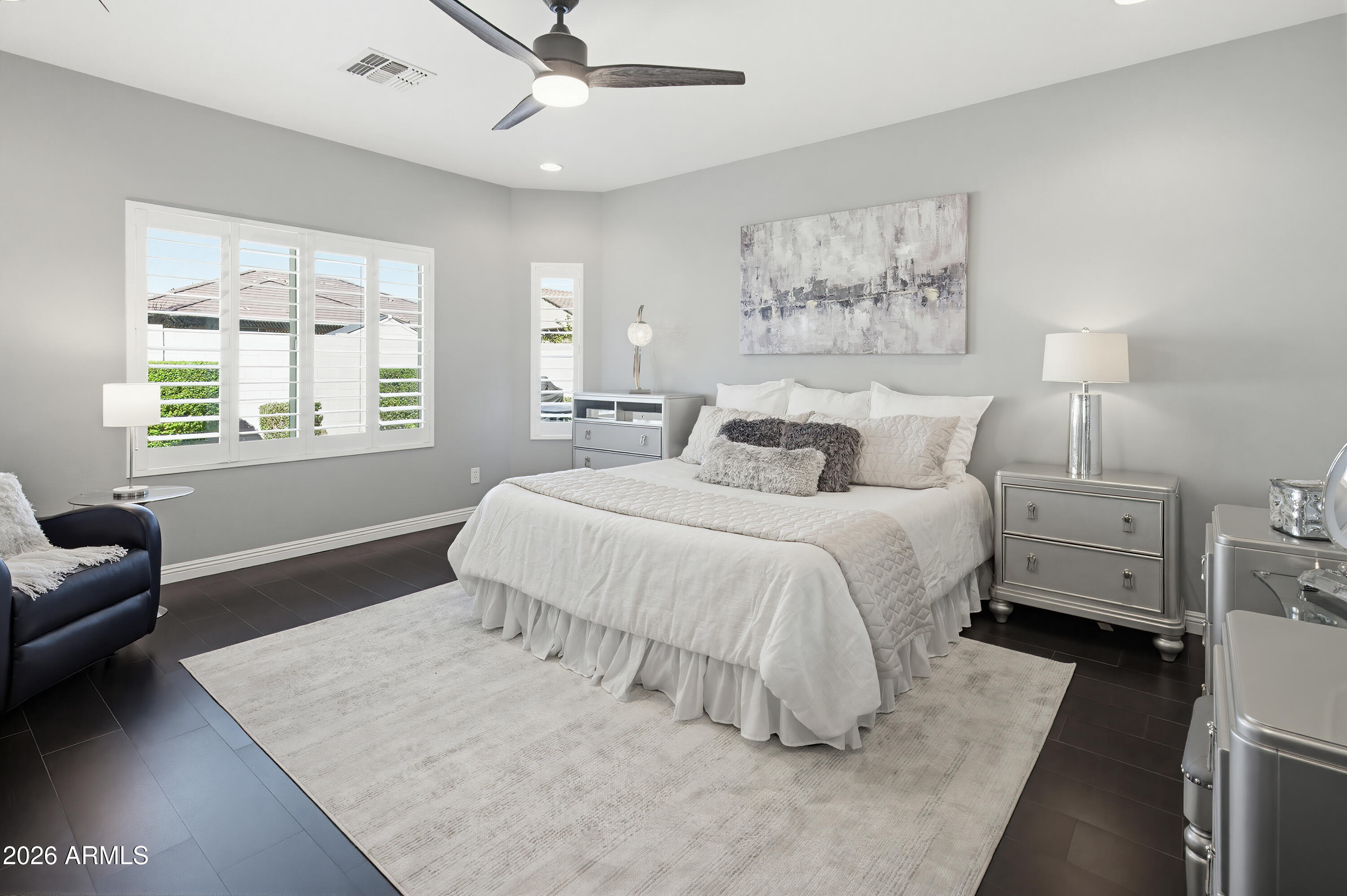 10772 West Yearling Road Peoria, AZ 85383 - Photo 6 of 39 a bedroom with a bed and a couch