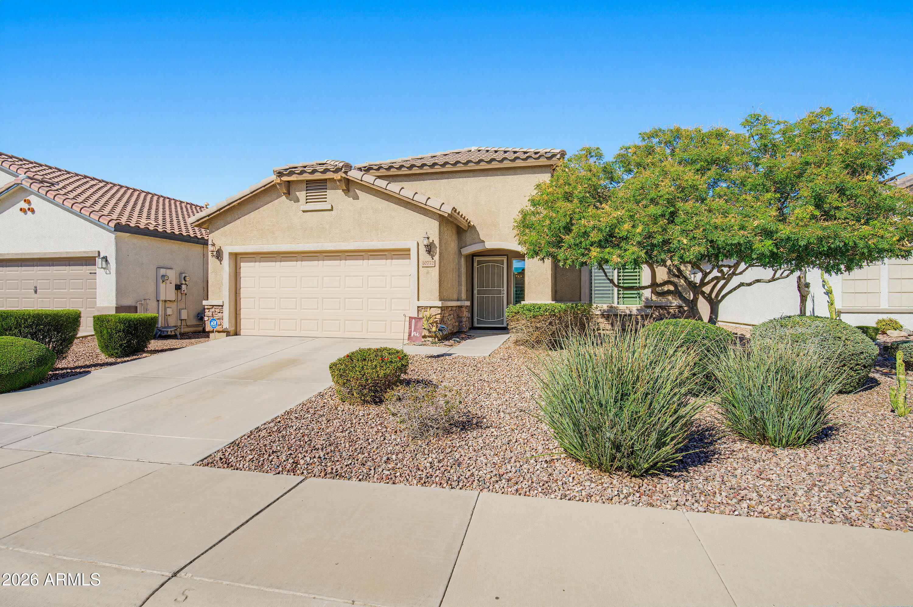 10772 West Yearling Road Peoria, AZ 85383 - Photo 7 of 39 a front view of a house with a garden