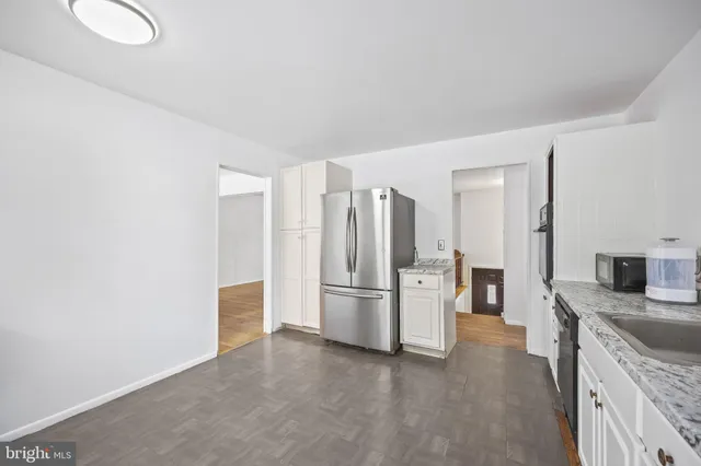 a kitchen with stainless steel appliances granite countertop a refrigerator and a stove