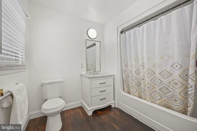 a bathroom with a toilet a sink and a window