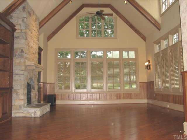 The family room enjoys panoramic views of the 18th fairway. Features include bookshelves with custom lighting, surround sound,LCD TV, a soaring stone gas fireplace, Australian cypress floors, 20 ft vaulted and beamed ceiling, and plantation shutters. Other