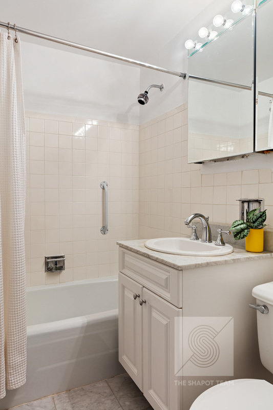 170 West End Avenue, Unit 2N Manhattan, NY 10023 - Photo 10 of 12 a bathroom with a sink a toilet and shower