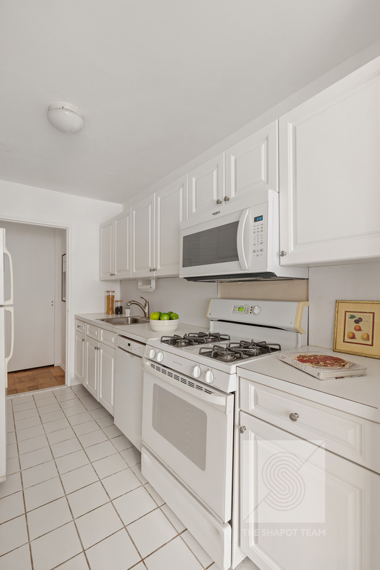 170 West End Avenue, Unit 2N Manhattan, NY 10023 - Photo 4 of 12 a kitchen with cabinets appliances and a sink