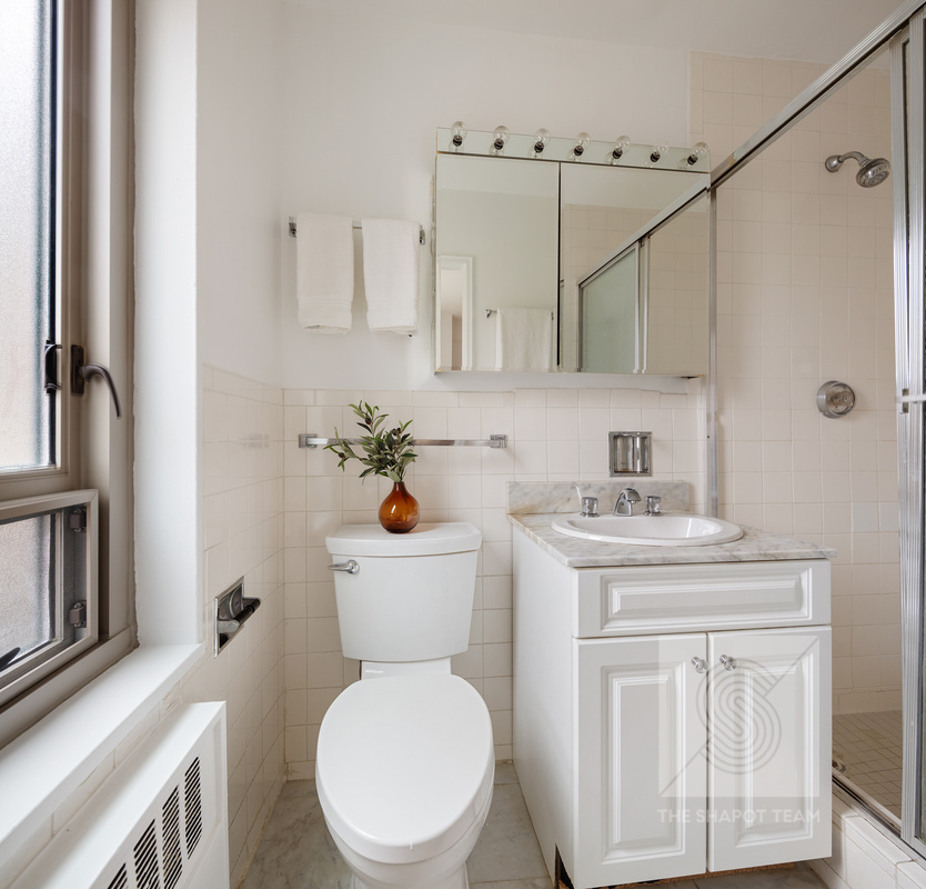 170 West End Avenue, Unit 2N Manhattan, NY 10023 - Photo 8 of 12 a bathroom with a sink a toilet and shower