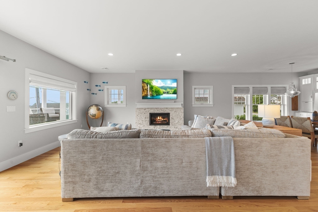 15 Buttonwood Lane Scituate, MA 02066 - Photo 12 of 42 a living room with fireplace furniture and a wooden floor