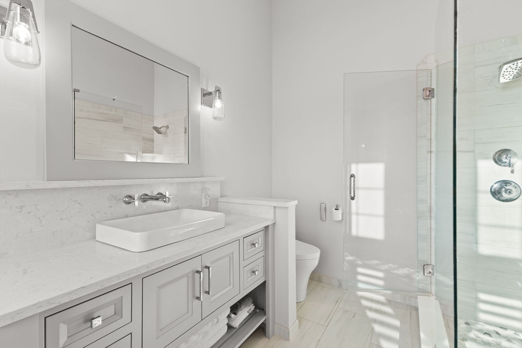 15 Buttonwood Lane Scituate, MA 02066 - Photo 21 of 42 a bathroom with a sink and a mirror