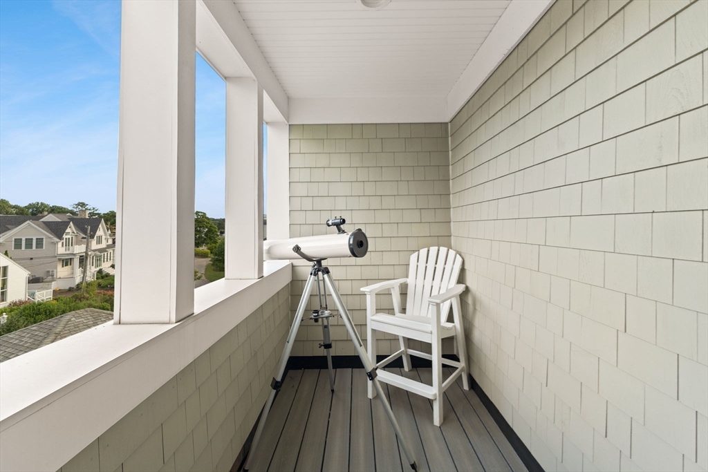 15 Buttonwood Lane Scituate, MA 02066 - Photo 29 of 42 a view of balcony with a table and chairs