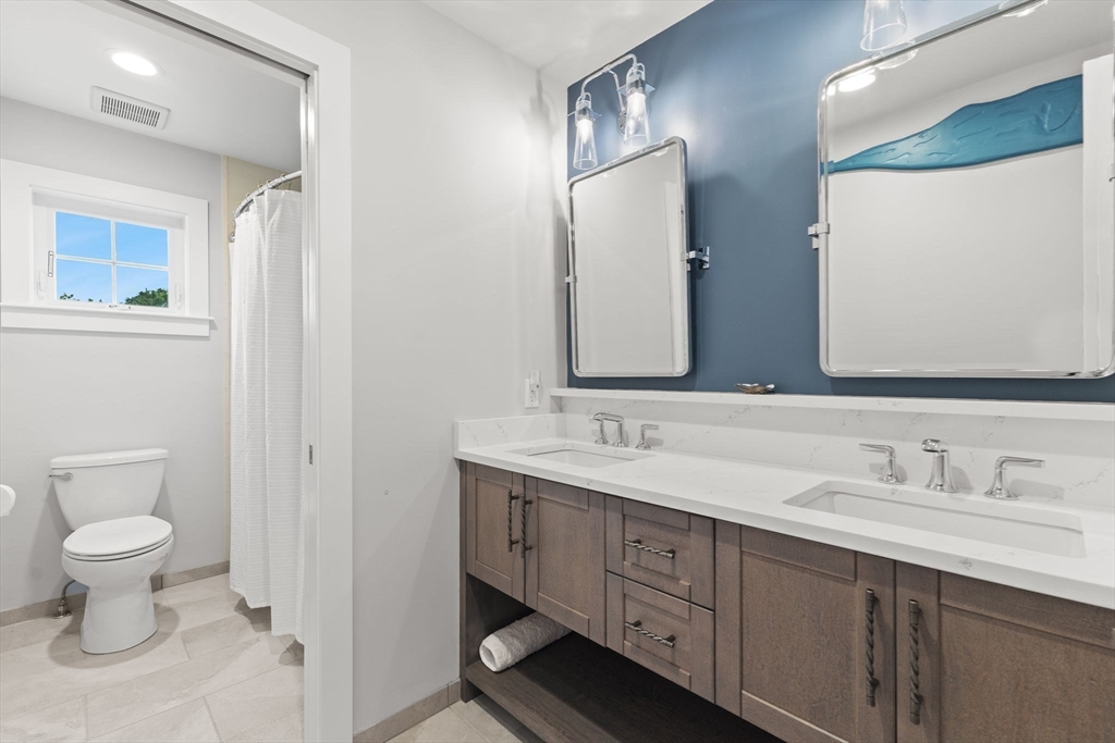 15 Buttonwood Lane Scituate, MA 02066 - Photo 30 of 42 a bathroom with a toilet sink and mirror