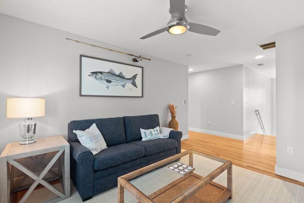 15 Buttonwood Lane Scituate, MA 02066 - Photo 33 of 42 a living room with furniture a rug and a lamp