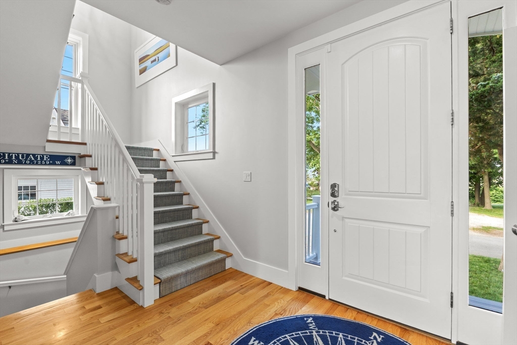15 Buttonwood Lane Scituate, MA 02066 - Photo 4 of 42 a view of entryway with wooden floor and stairs