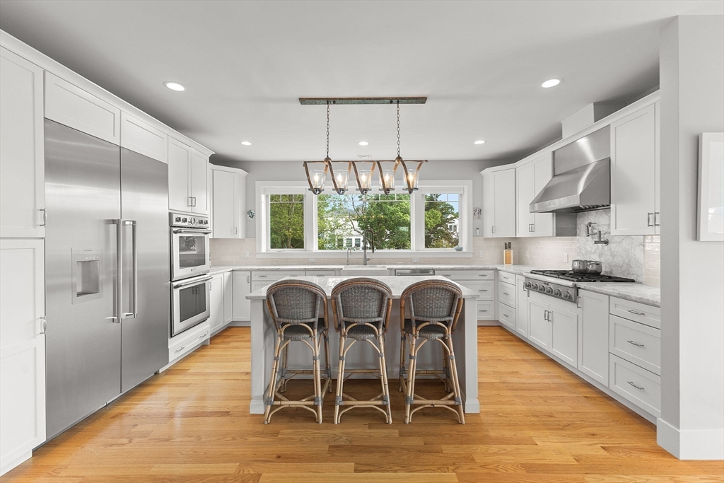 15 Buttonwood Lane Scituate, MA 02066 - Photo 9 of 42 a kitchen with stainless steel appliances granite countertop a stove a refrigerator and a dining table
