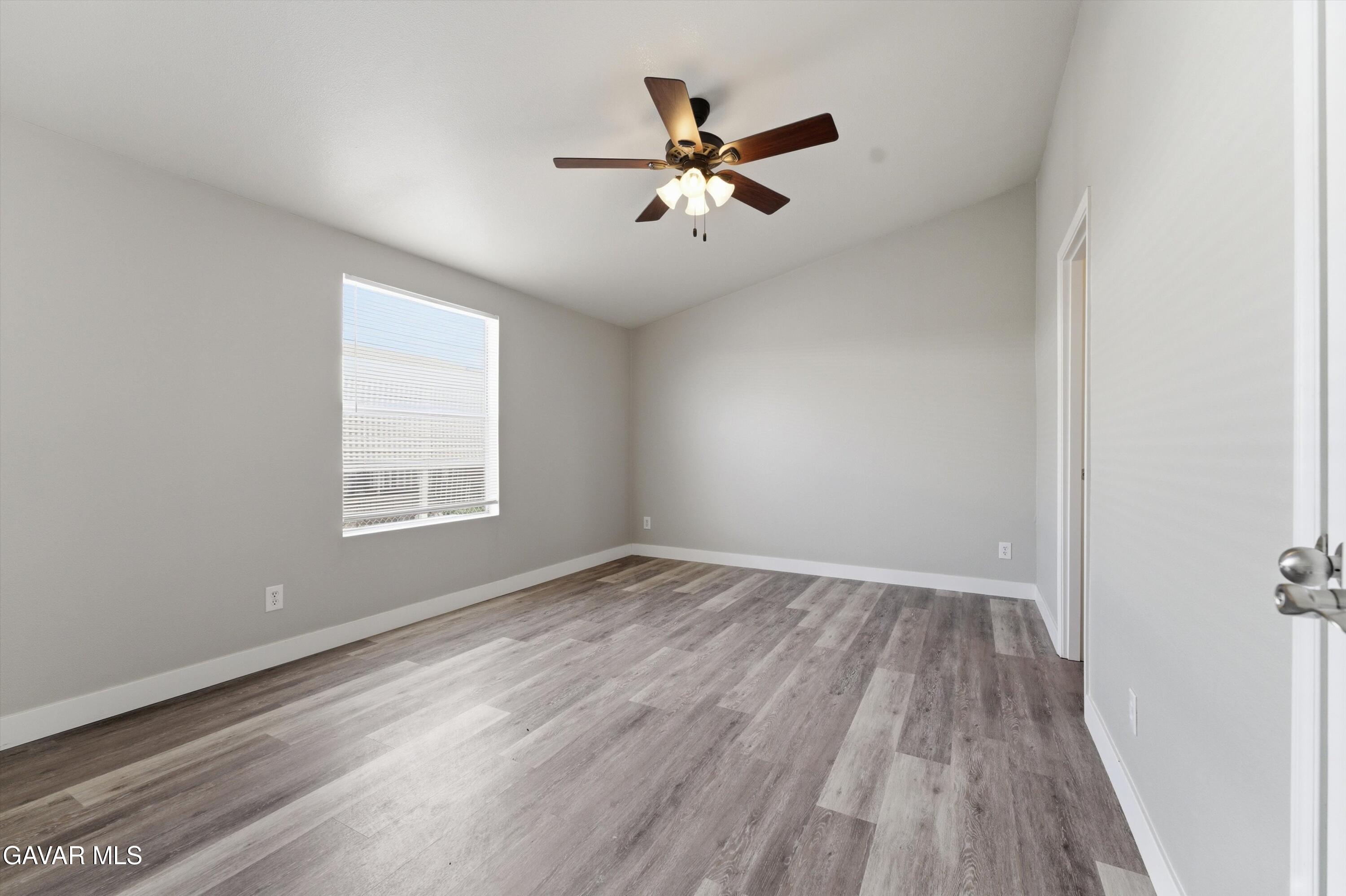 20843 Waalew Road Apple Valley, CA 92307 - Photo 15 of 40 wooden floor in an empty room with a window