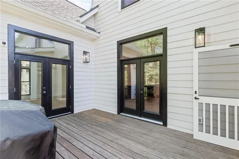 a view of an empty room with a fireplace and a window