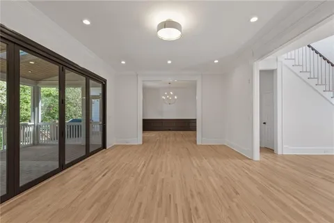a view of an empty room with window and fire place