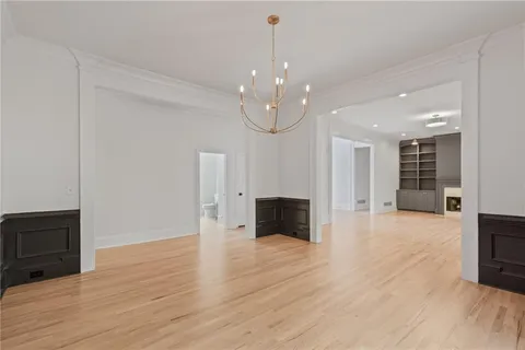 a view of an empty room with glass door and a balcony