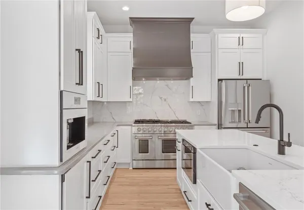 a large white kitchen with a large window