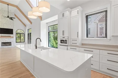 a view of an entryway with a fireplace a chandelier and wooden floor