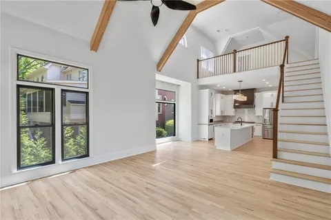 a view of entryway and hall with wooden floor
