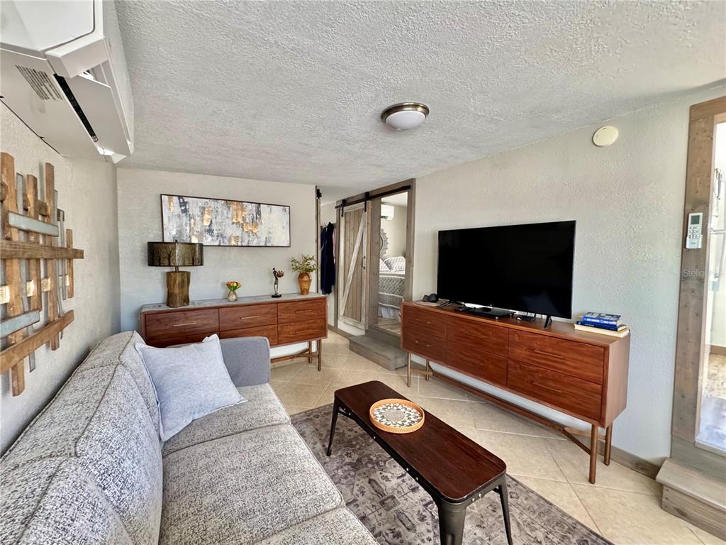 10315 Cortez Road West, Unit 643 Bradenton, FL 34210 - Photo 13 of 52 a living room with furniture and a flat screen tv