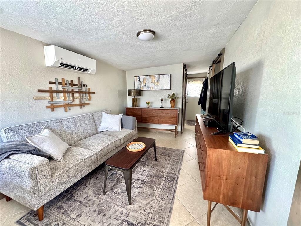 10315 Cortez Road West, Unit 643 Bradenton, FL 34210 - Photo 15 of 52 a living room with furniture and a flat screen tv