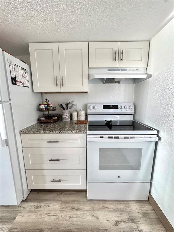10315 Cortez Road West, Unit 643 Bradenton, FL 34210 - Photo 25 of 52 a kitchen with white cabinets stainless steel appliances and sink