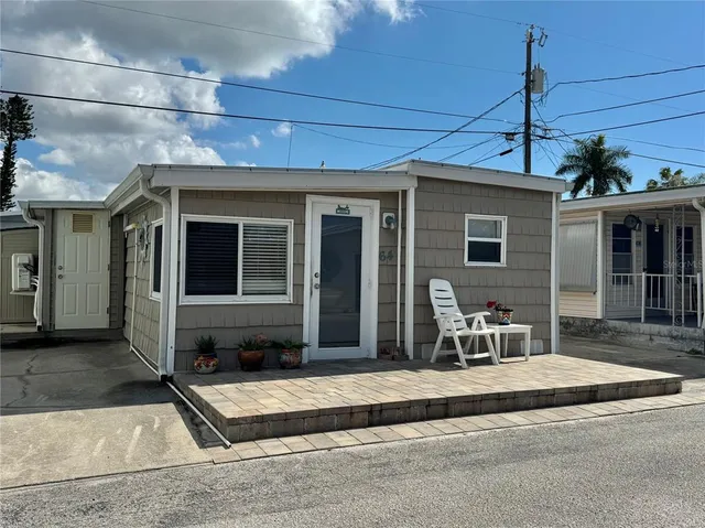 a front view of a house with a sitting area