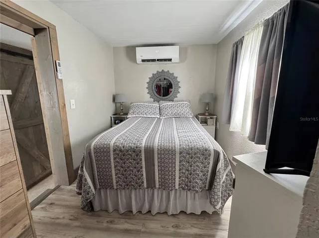 a bedroom with a bed and a mirror