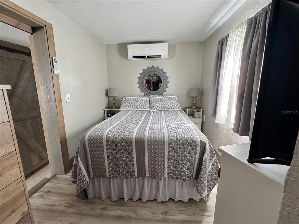 10315 Cortez Road West, Unit 643 Bradenton, FL 34210 - Photo 31 of 52 a bedroom with a bed and wooden floor