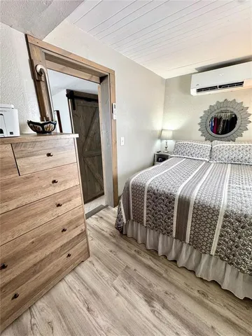 a bed room with a bed and a mirror