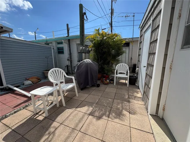 a patio with table and chairs