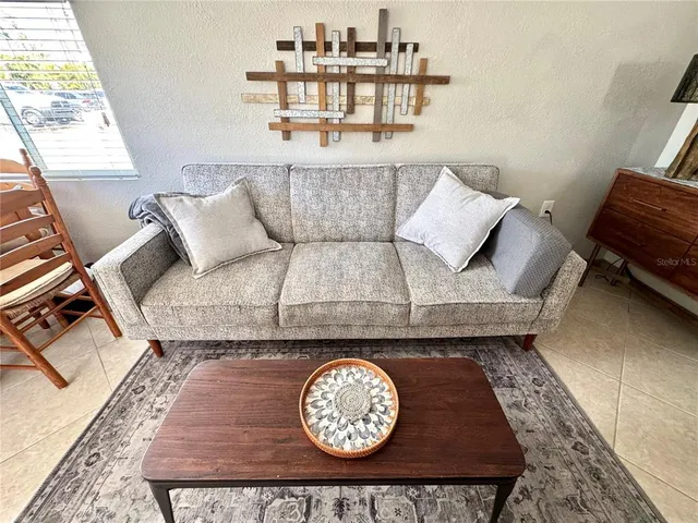 a view of living room with furniture and window