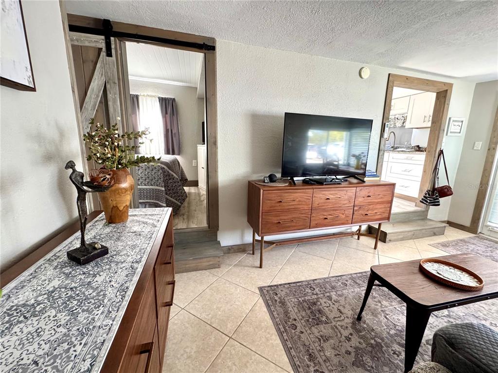 10315 Cortez Road West, Unit 643 Bradenton, FL 34210 - Photo 9 of 52 a living room with furniture and a flat screen tv